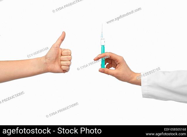 hand with medicine and showing thumbs up