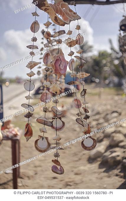 Stand full of dreamcatchers made with shells in a small street of Isla Mujeres in Mexico