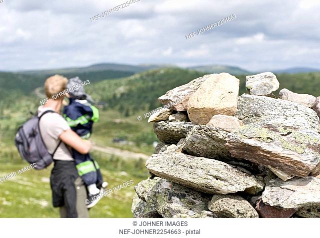 Stack of stones, father with child on background