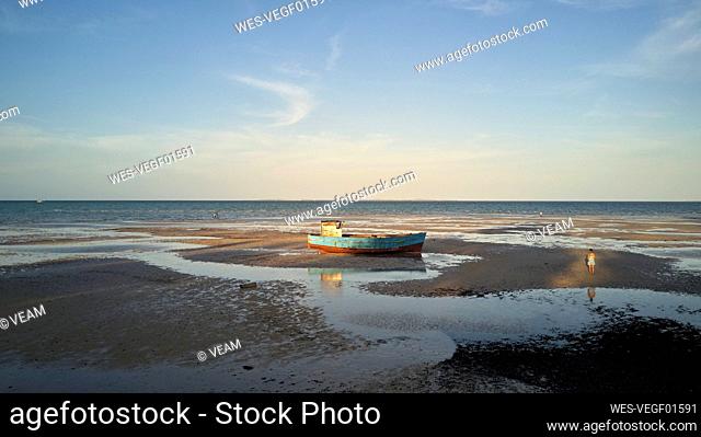 Mozambique Vilanculos, Aerial view of an old boat at the beach at low tight
