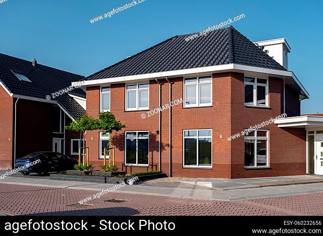Dutch Suburban area with modern family houses, newly build modern family homes in the Netherlands, dutch family house, apartment house. Netherlands