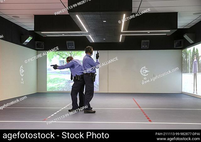 10 November 2021, Saxony, Schneeberg: Two police officers train on the new space shooting range of the police technical school