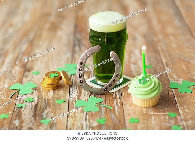 glass of beer, cupcake, horseshoe and gold coins