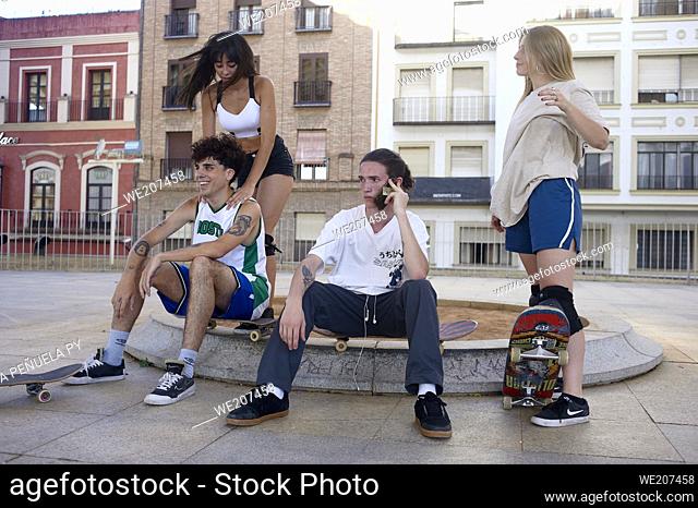 Group of young people riding on skateboards in the city