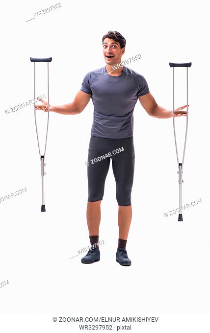 Young patient athlete sportsman suffering an injury trauma with crutches isolated on white