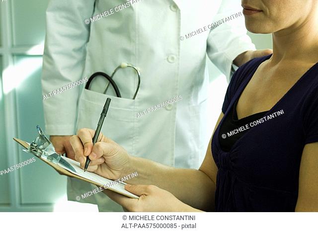 Patient completing medical paperwork