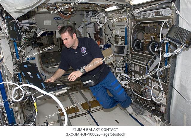Astronaut Greg Chamitoff, Expedition 17 flight engineer, works with the Microgravity Sciences Glovebox and the Commercial Generic Bioprocessing Apparatus in the...