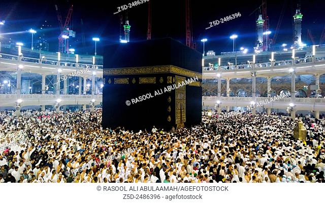 Picture of the Kaaba and a group of pilgrims they walk around to perform Hajj or Umrah, and all Muslims follow its, Located in Mecca in Saudi Arabia