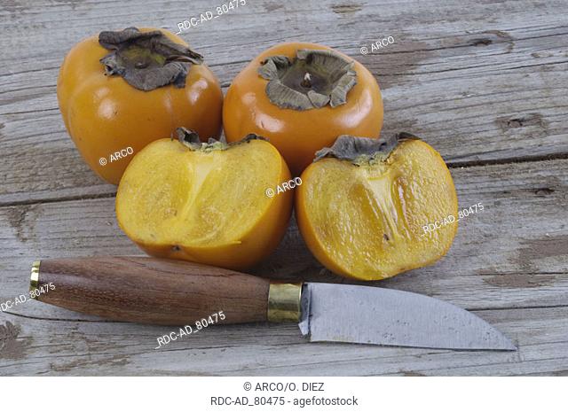 Japanese Persimmon fruits and knife Diospyros kaki Ebenaceae