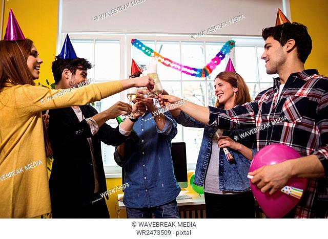 Business people toasting drink at birthday party