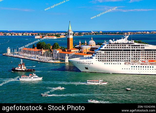 Cruise ship moving through San Marco canal in Venice, Italy. Venice is situated across a group of 117 small islands that are separated by canals and linked by...