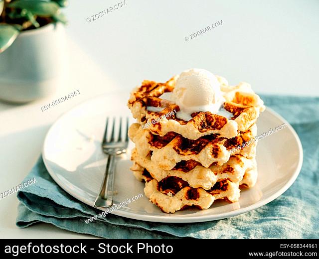 Ricotta cheese chaffles for keto diet. Stack of ricotta and lemon belgian waffles decorated with ice cream scoop. Copy space for text or design