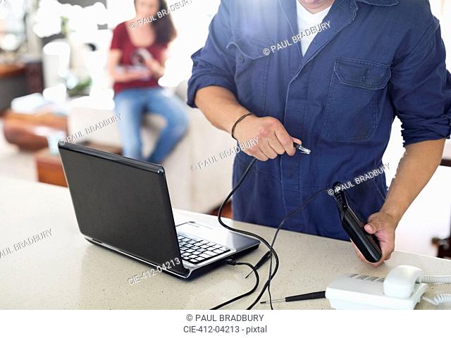 Electrician using laptop in home