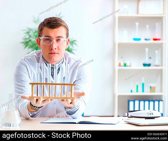 The young chemist student experimenting in lab