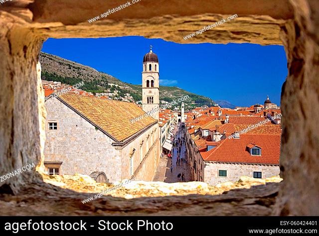 Dubrovnik. Famous Stradun street in Dubrovnik view through stone window, Dalmatia region of Croatia