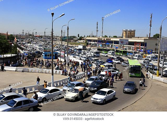 Tashkent, Uzbekistan - May 12, 2017: View of traffic and huge crowd at Kuilyuk Bazaar market area, one of the most busiest commercial place in the city