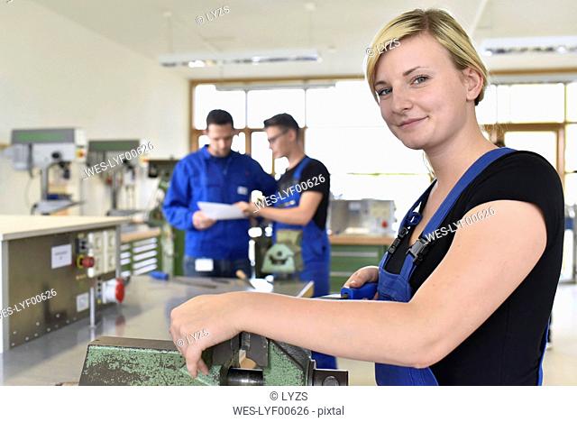 Portrait of smiling female trainee in workshop