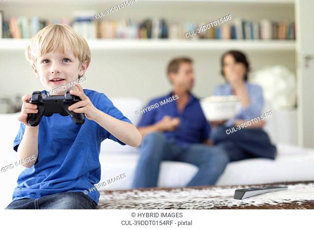 Boy playing video games in living room