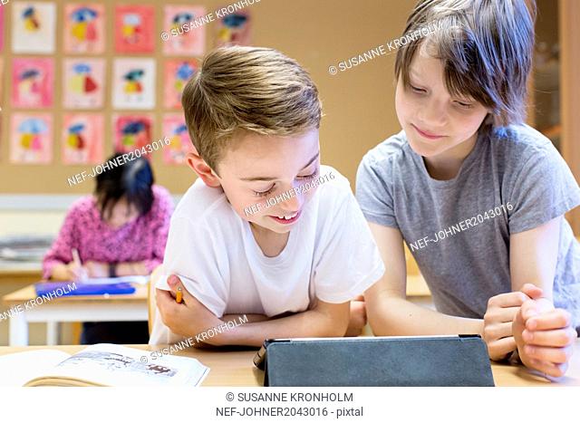 Boys using digital tablet