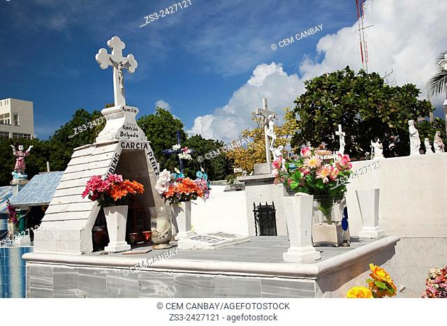 Statues and flowers on the tombstone in cemetery, Isla Mujeres, Cancun, Quintana Roo, Yucatan Province, Mexico, Central America