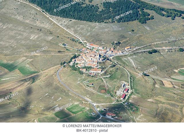 Aerial view of Piano Grande plateau and village of Castelluccio di Norcia, Monti Sibillini National Park, Umbria, Italy