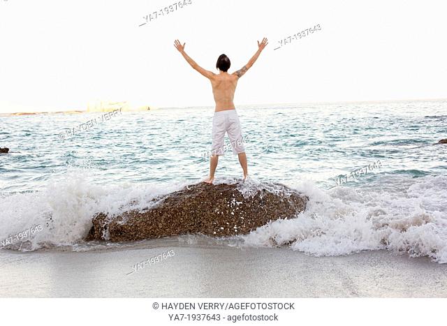 Man Stood On Rock on The Beach