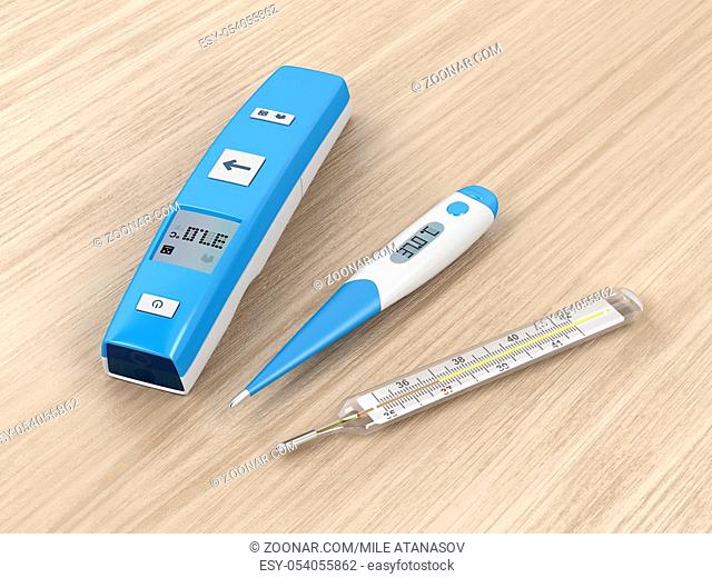 Different types of medical thermometers on wood background