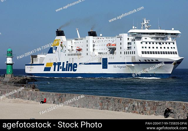 09 April 2020, Mecklenburg-Western Pomerania, Rostock: The ferry ""Nils Holgersson"" of the shipping company TT-Line enters the sea channel to the seaport...
