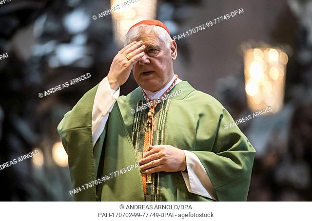 Cardinal Gerhard Ludwig Muller crosses himself during his sermon in the Cathedral in Mainz, Germany, 02 July 2017. The previous day it became known that Pope...