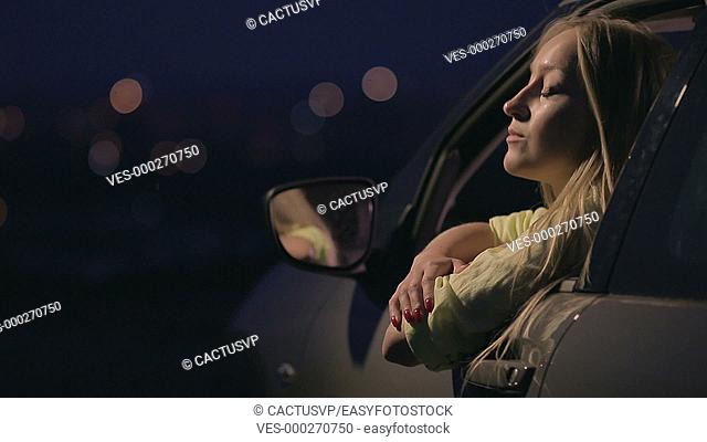 Thoughtful woman enjoying landscape of night city