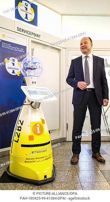 25 April 2018, Germany, Ludwigsburg: Werner Spec (non-afiliated), mayor of Ludwigsburg, standing beside the service robot ""L2B2"" during its presentation by...