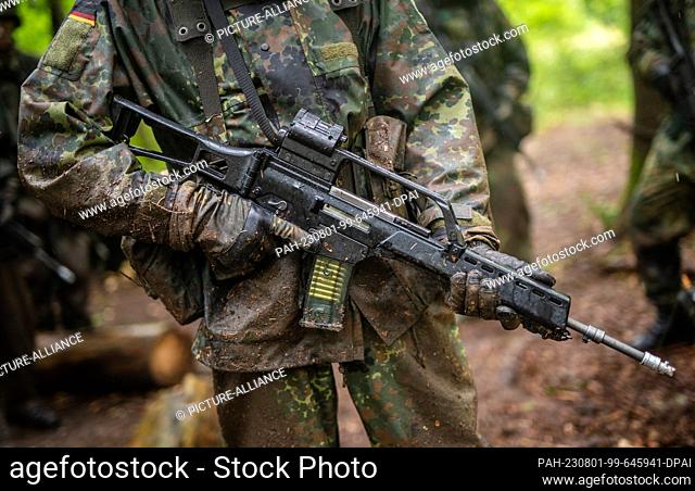 01 August 2023, Baden-Württemberg, Stetten am kalten Markt: A Bundeswehr reservist holds a Heckler & Koch G36 assault rifle in his hands at a Bundeswehr...