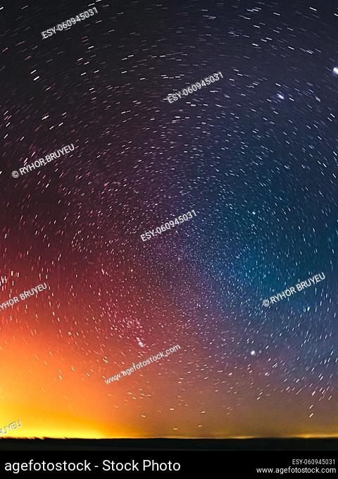 Amazing Night Sky Glowing Stars Background Backdrop In Rotation. Colorful Sky Gradient. Sunset Sunrise Light And Colourful Night Starry Sky In Blue Yellow Pink...