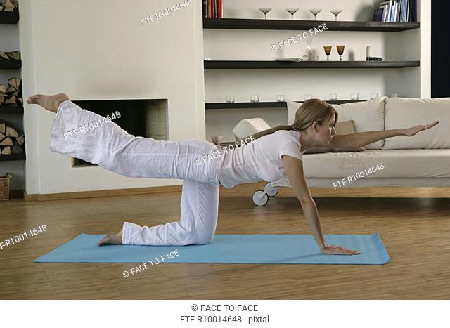 A blonde woman performing an exercise on the floor