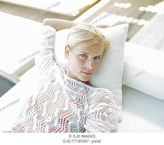 A woman lying down looking serious