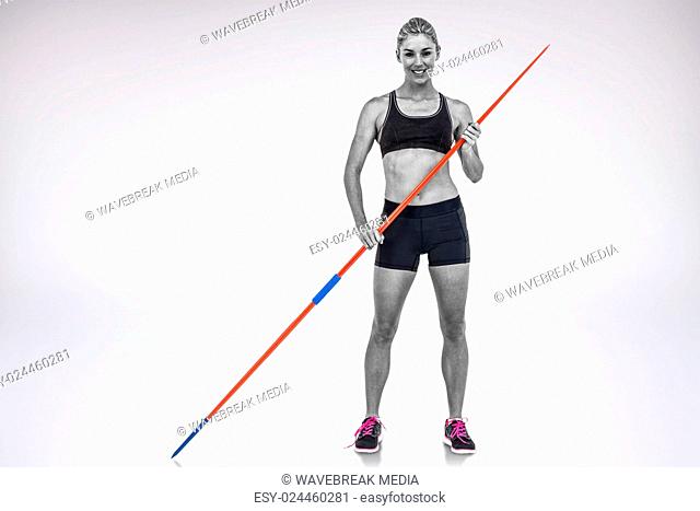 Composite image of athlete standing with javelin