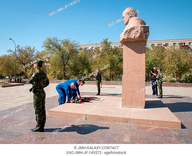 The Expedition 49 backup crewmembers lay flowers at the statue of Soviet rocket Great Designer Sergey Korolev during a tour of the city of Baikonur