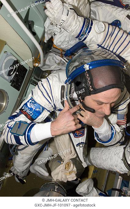 NASA astronaut Don Pettit, Expedition 31 flight engineer, prepares for a Sokol suit standard leak check in the Soyuz TMA-03M spacecraft in preparation for his...