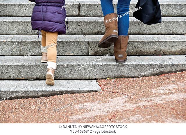 woman walking up the stairs with a little girl, Geneva, Switzerland