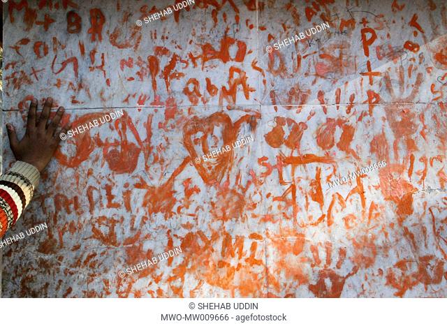 A Hindu pilgrim puts his hand print to the faith wall in Pashupati Nath temple The religious festival Maha Shivaratri, the night of Lord Shiva