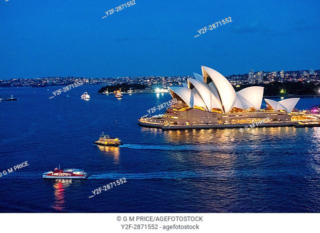 Sydney Harbour at dusk with boats and opera house