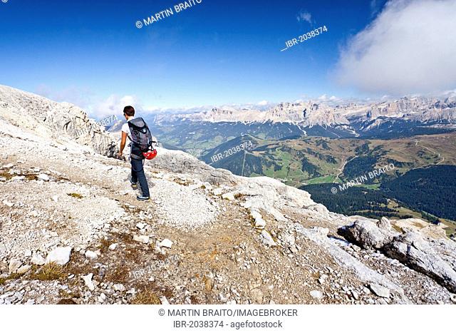 Mountain climber climbing the Boeseekofel Climbing Route, looking towards the Fanes Group and the Heiligkreuzkofel Group, Dolomites, Trentino, Italy, Europe