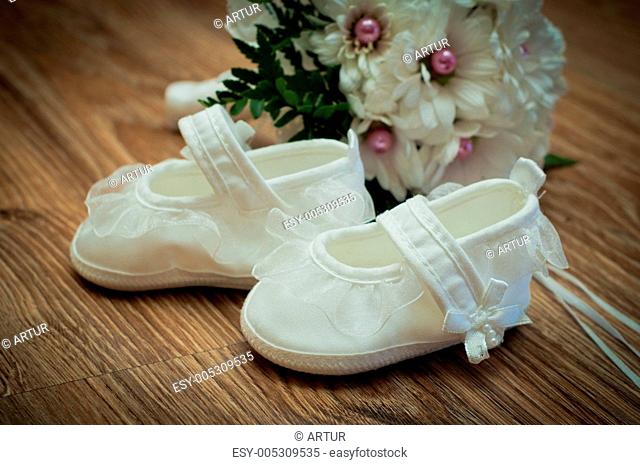 shoes and bouquet on a wooden floor