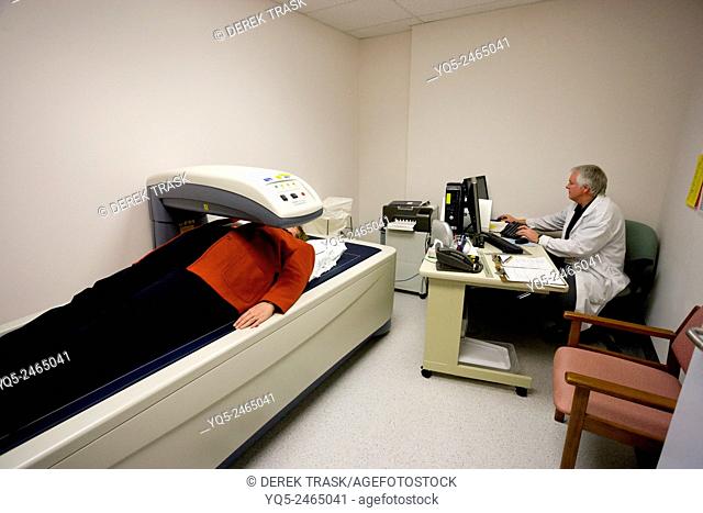 patient receives bone density scan used to measure calcium content of bone and bone loss