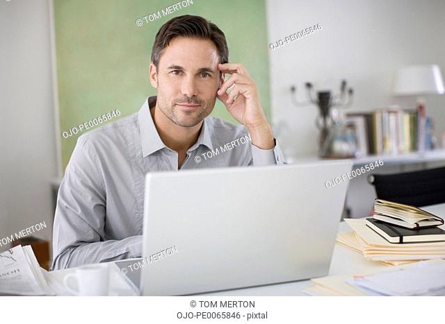 Man using laptop at desk