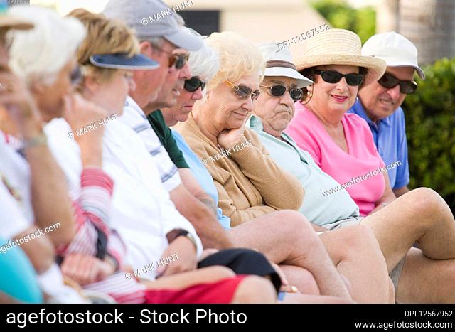Senior people sitting side by side
