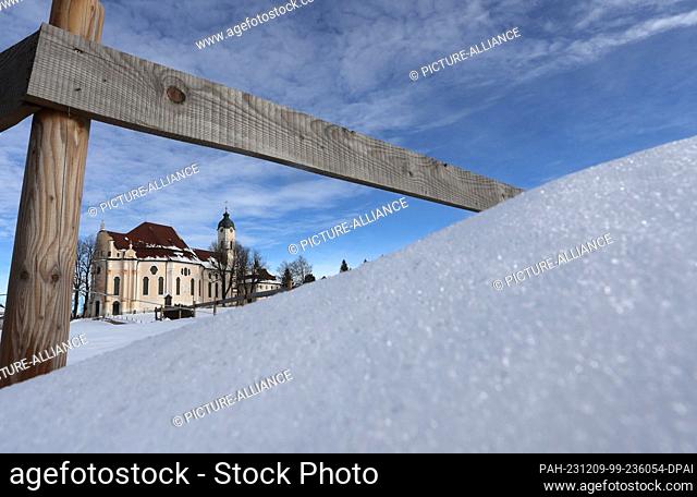 09 December 2023, Bavaria, Steingaden: The Wieskirche church stands in the sunshine in a snow-covered landscape. Photo: Karl-Josef Hildenbrand/dpa