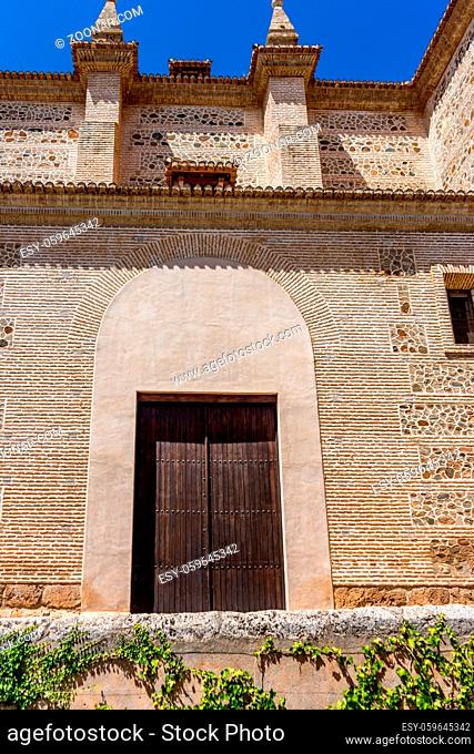 Moorish Islamic Arch above a wooden door in Granada, Spain, Europe on a bright sunny day