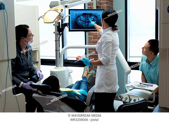 Female dentist explaining dental x-ray report