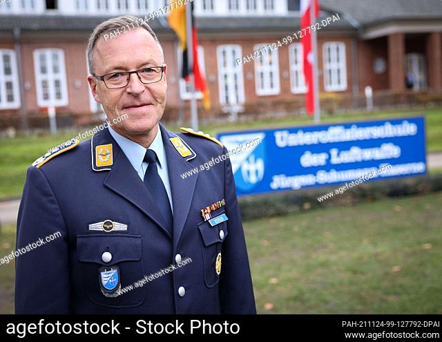 24 November 2021, Schleswig-Holstein, Appen: Thomas Berger, Commander of the Air Force NCO School, stands next to the new sign with the text ""Air Force NCO...